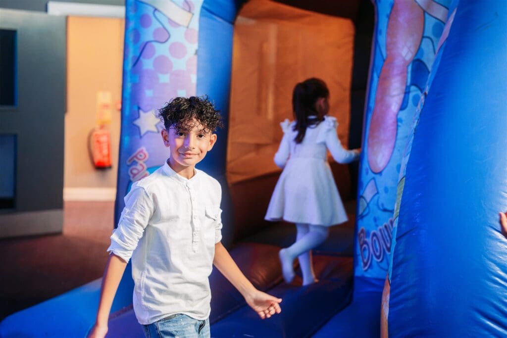 Kids bouncing on the bouncy castle at a Vibe kids party